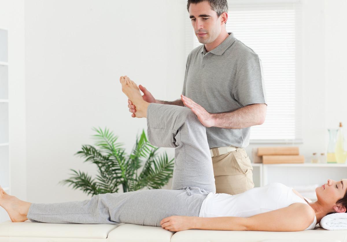 Man working on woman's leg